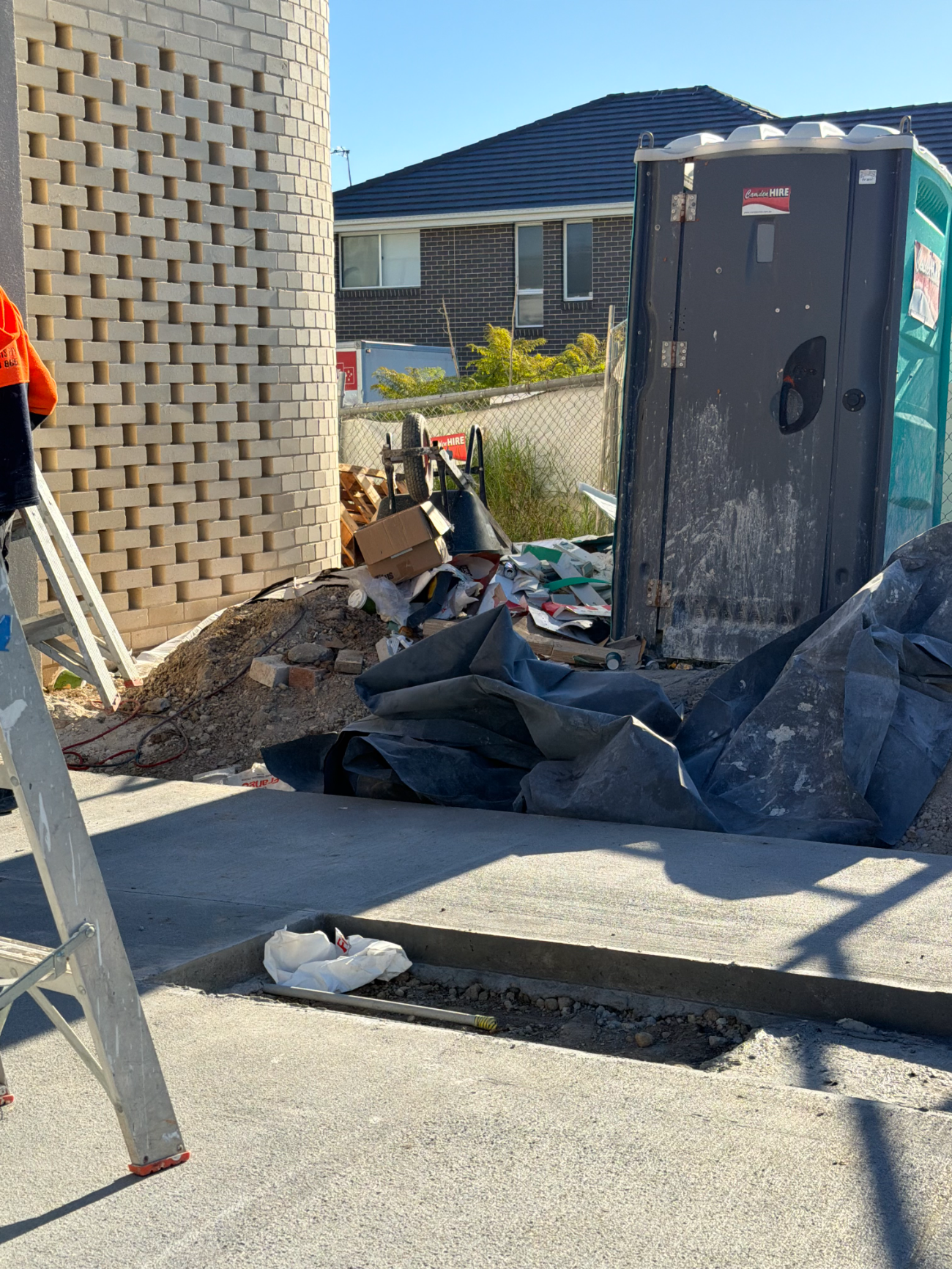 Site entrance piled with builders' rubbish before removal